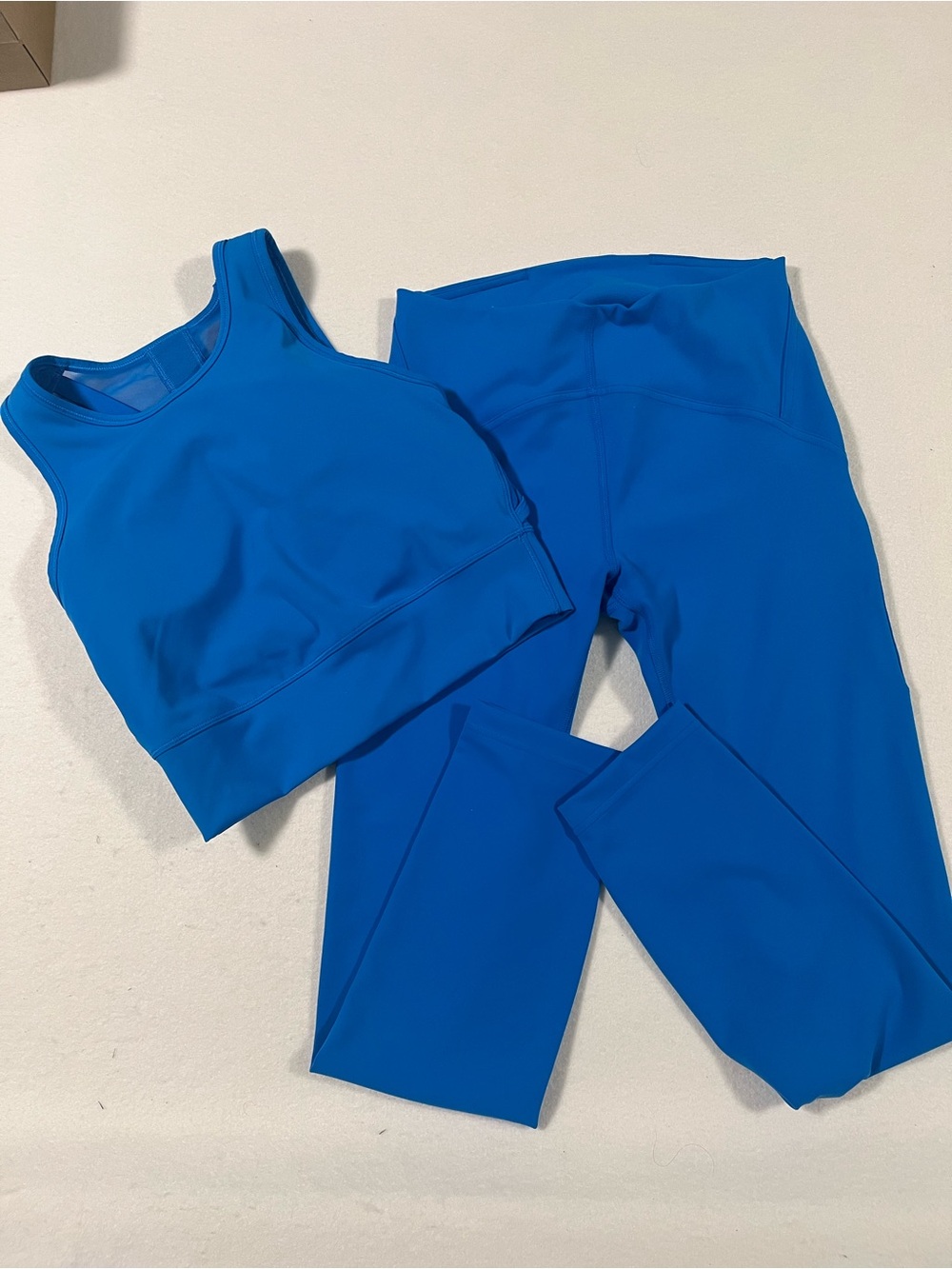 Lululemon Bright Blue High-Waist Leggings and High Neck Mesh back Halter Bra.